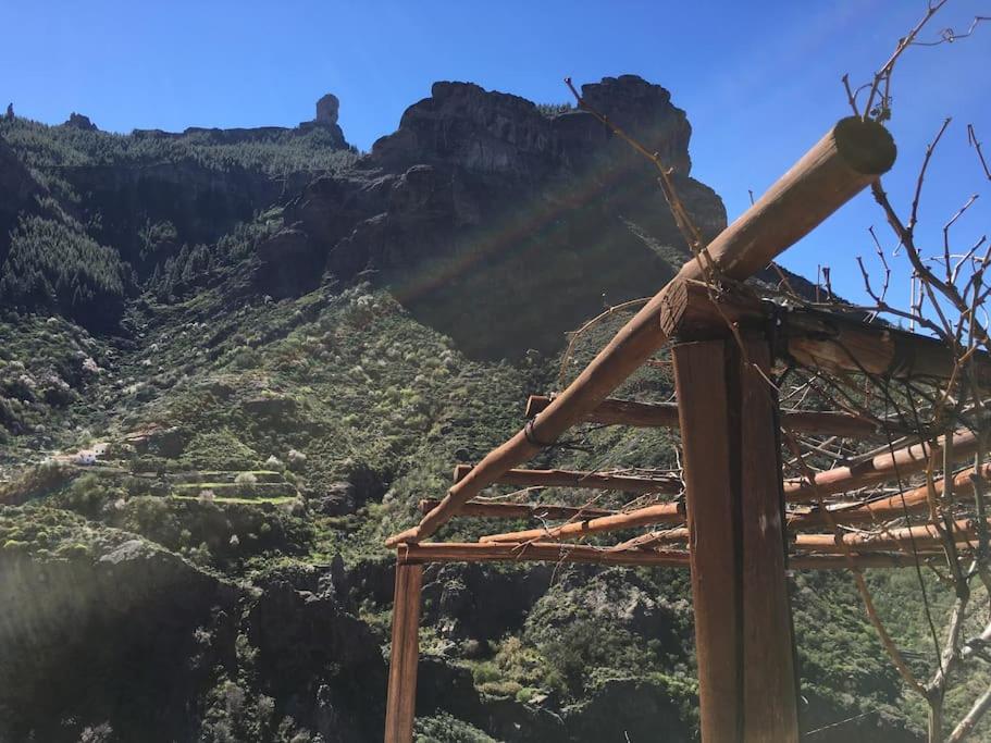 a view of a mountain with the sun shining on it at Casa rural El Lomito in Tejeda