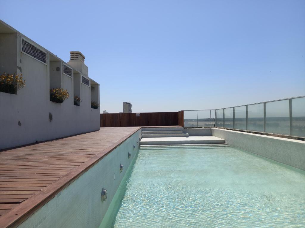 a swimming pool on the roof of a building at Monoambiente con cochera en Puerto Norte in Rosario