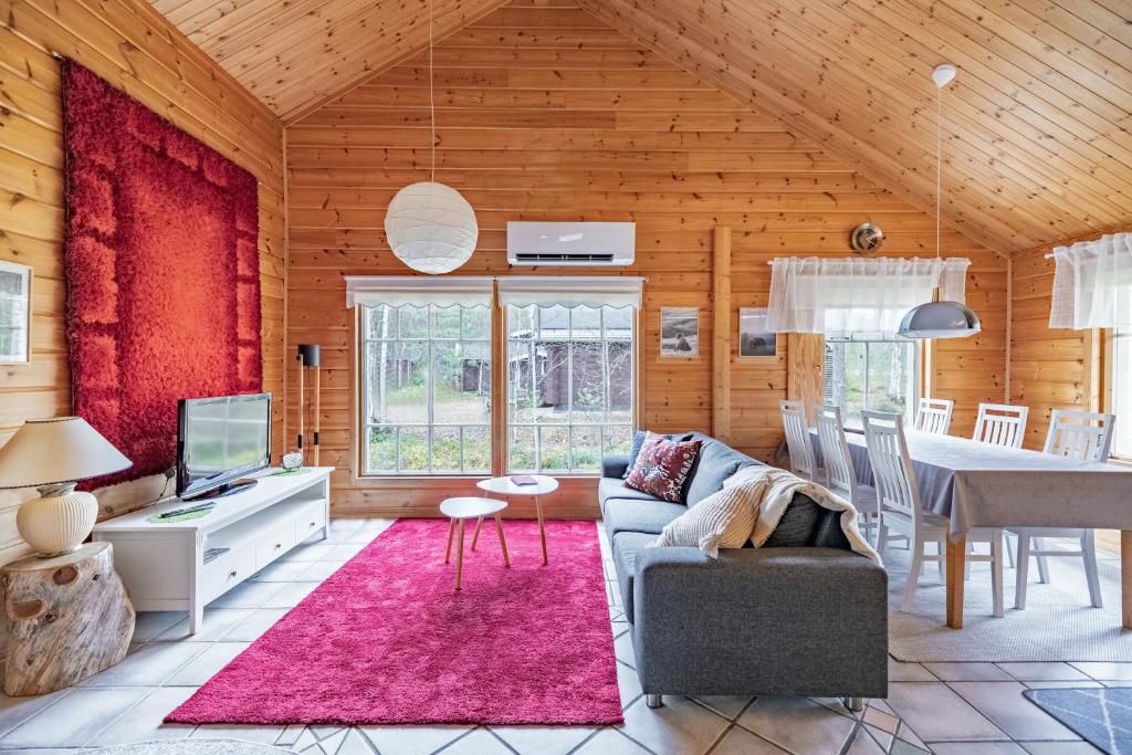 a living room with a couch and a table at Pyhä Nallentupa in Kemijärvi