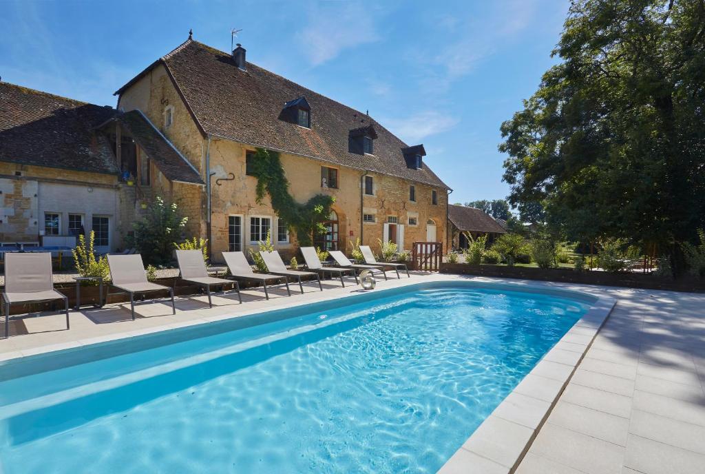 a swimming pool in front of a house at Domaine de Bersaillin in Bersaillin