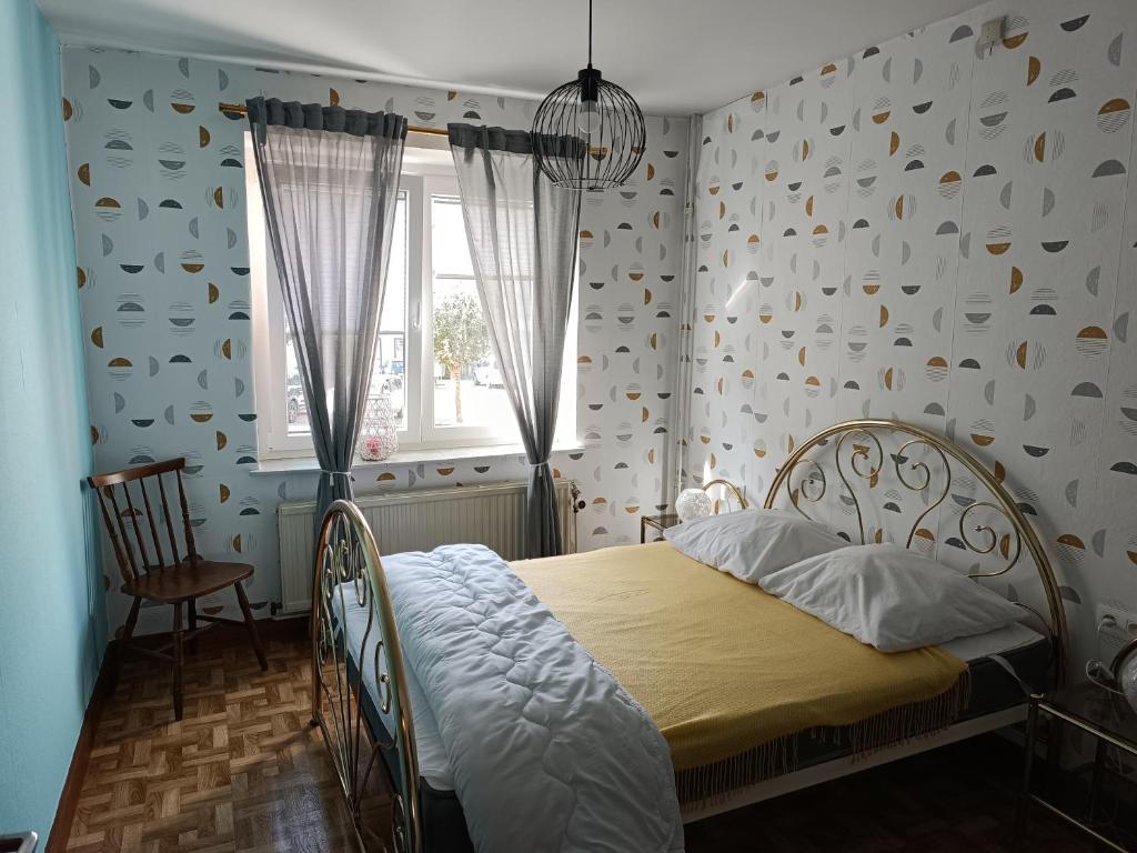 1 dormitorio con cama y ventana en Fairie's Little House, en Houffalize