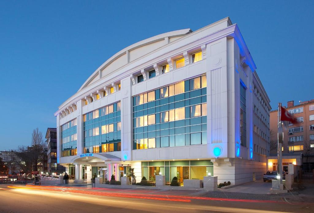 a large white building on the corner of a street at Ankara Plaza Hotel in Ankara