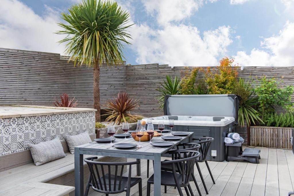 a patio with a table and chairs and a grill at Little Beach House by Bloom Stays in Whitstable