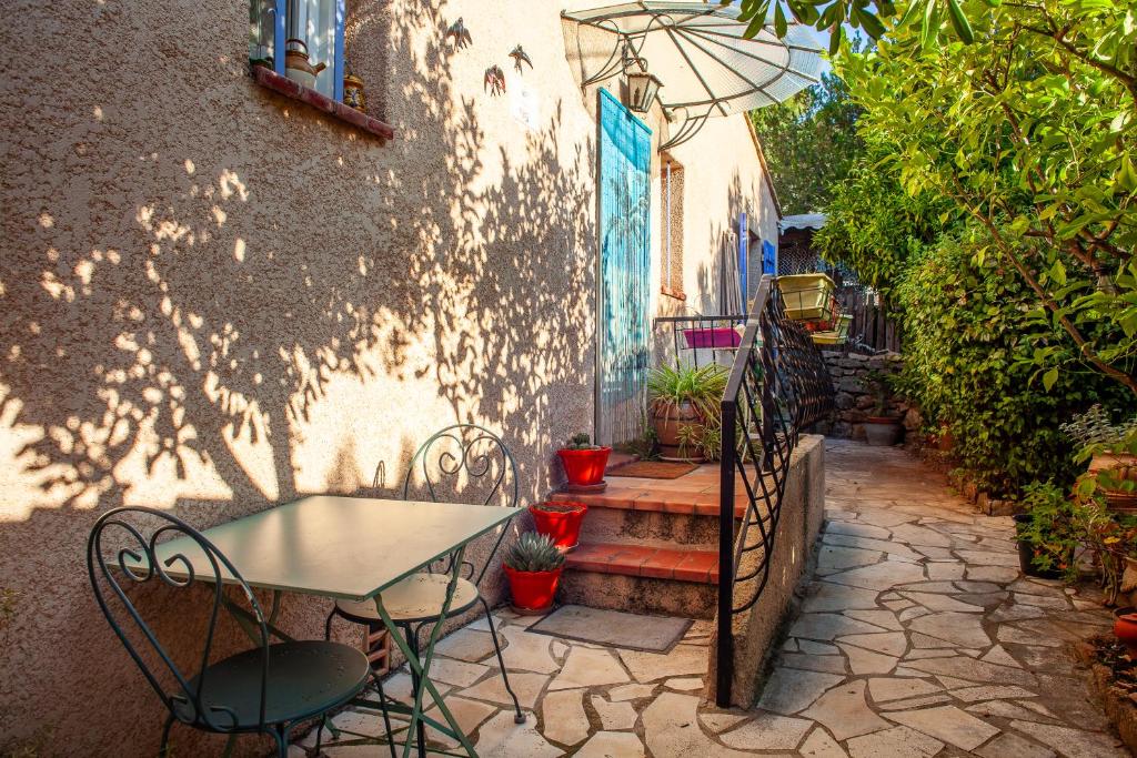 une table et des chaises installées à côté d'un bâtiment dans l'établissement La Figounette, à Le Revest-le-Eaux