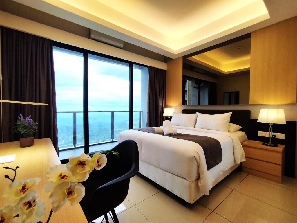 a bedroom with a large bed and a large window at TopGenting SkySunColdSuite5Pax at GrdIonDelmn in Genting Highlands