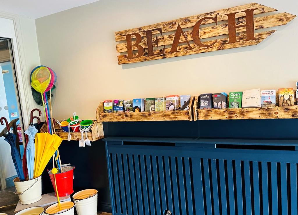 a room with a blue radiator and a sign that reads alert at Beach House Hotel in Seahouses