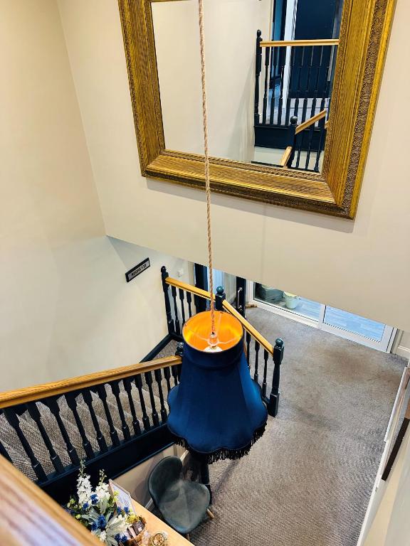 a mirror hanging on a wall next to a staircase at Beach House Hotel in Seahouses