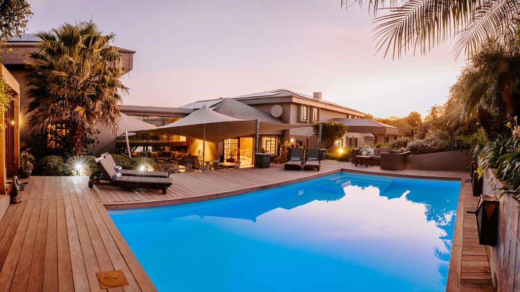 a swimming pool in front of a house at Kanonkop House in Knysna