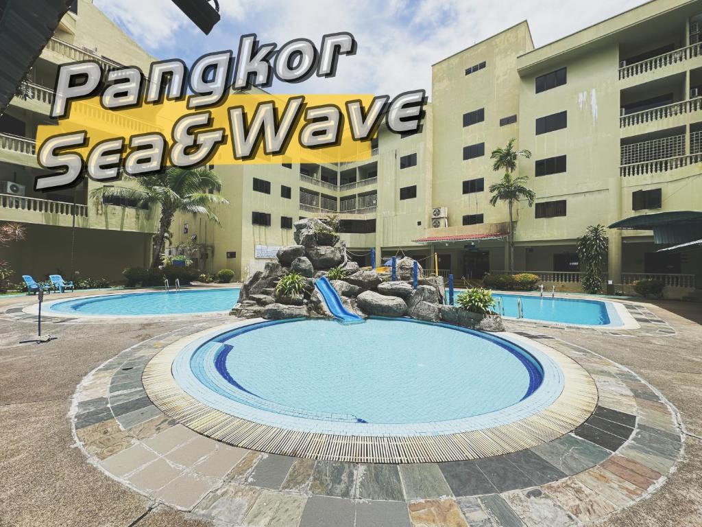 a pool at a resort with a water slide at Sea & Wave #1 Coral Bay Apartment in Pangkor