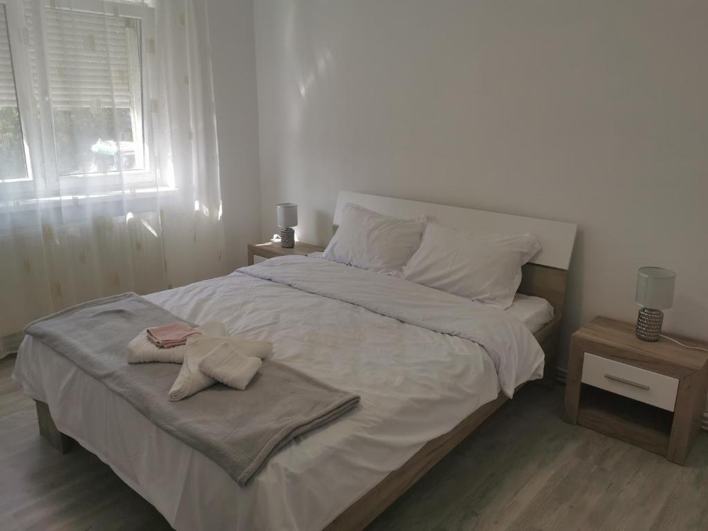 a bedroom with a large bed with a towel on it at Apartament Alba Iulia in Alba Iulia