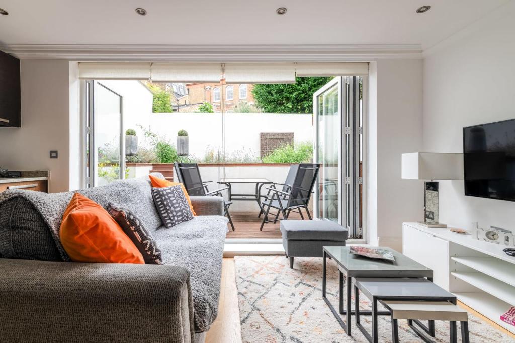 a living room with a couch and a table at Gorgeous Kentish Town Flat in London