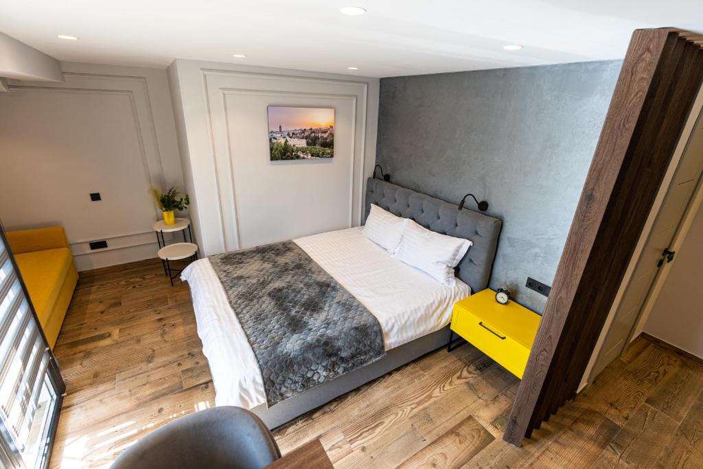 a bedroom with a bed and a yellow table at Apartments DREAM in Málaga