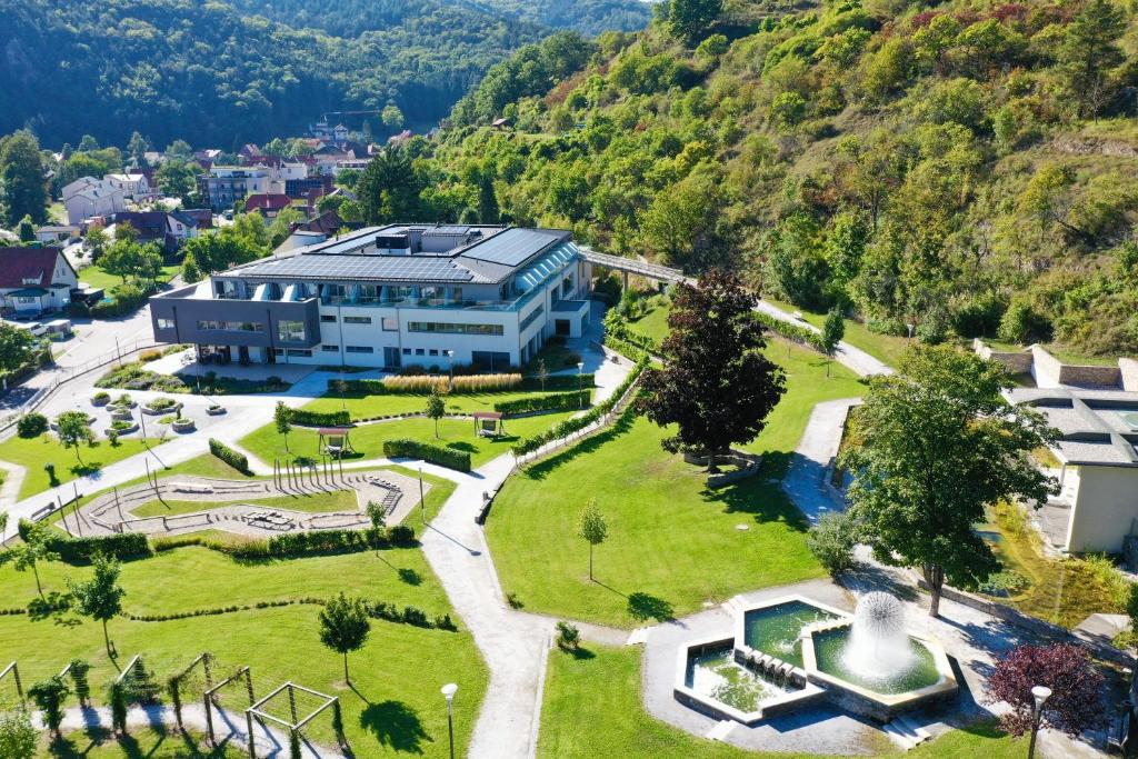 an aerial view of a building with a park at Nuhr Medical - Hotel & Restaurant in Senftenberg