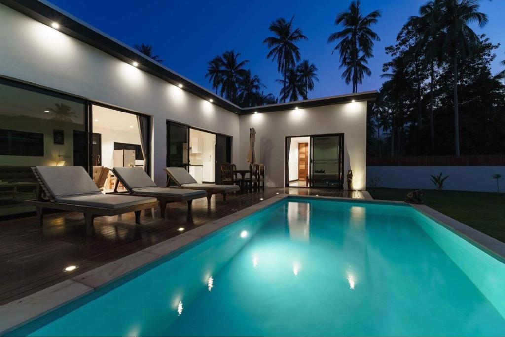 a swimming pool in the backyard of a house at Eden villas in Nathon Bay