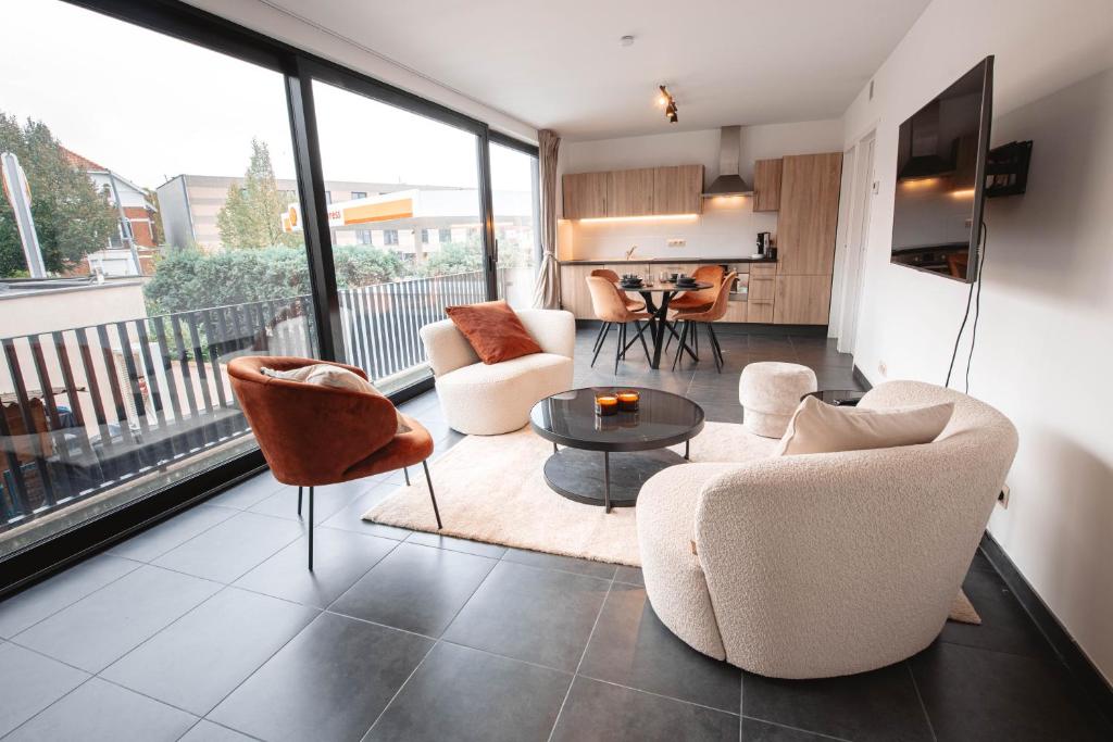 a living room with two chairs and a table at K&Y suites 2 ,500m to Brussels airport! in Zaventem
