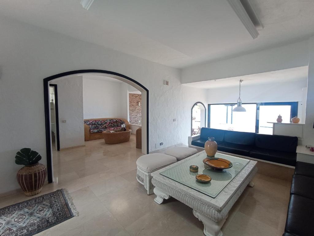 a living room with a table and a couch at Apartamento Faro de Sardina in Gáldar