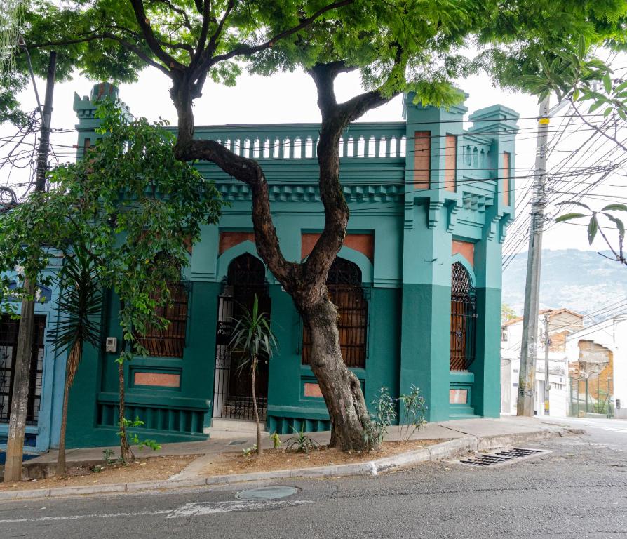 a blue building with a tree in front of it at Casa Moore in Medellín