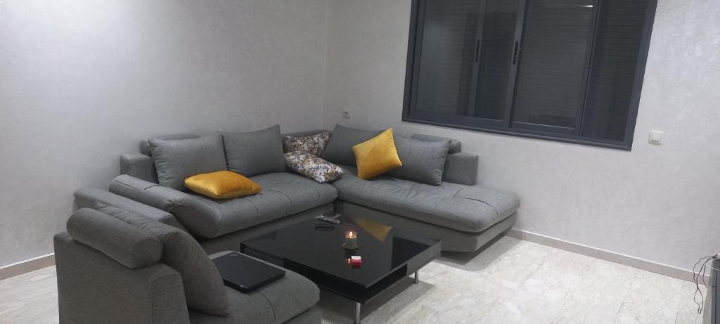 a living room with a couch and a coffee table at room in Residence Lilya fermée et sécurisée in Casablanca