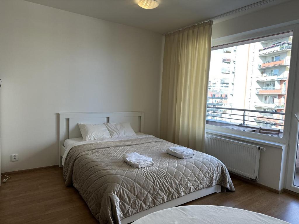 sypialnia z łóżkiem z dwoma ręcznikami w obiekcie Nomad Apartments w Pradze
