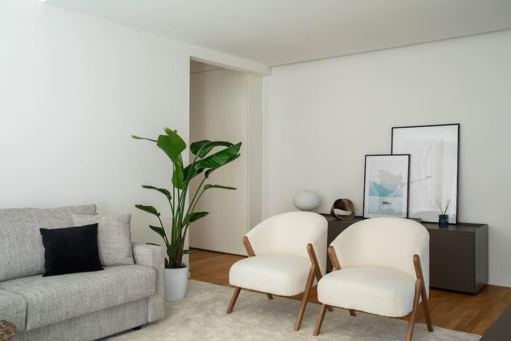 Una sala de estar con dos sillas y un sofá. en La Vacanza Bellagio, en Bellagio