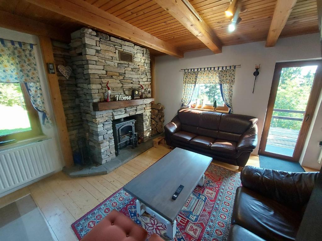 a living room with a couch and a fireplace at Rogla - Chalet Mojca Pokrajculja in Zreče