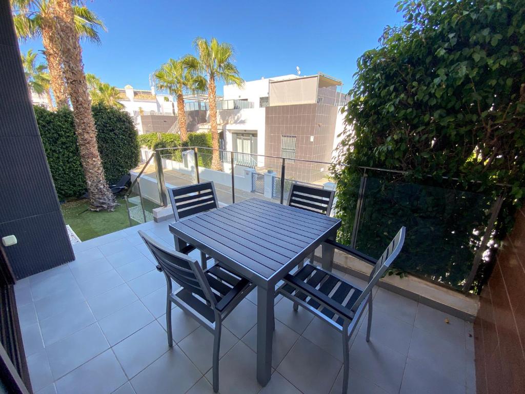a black table and chairs on a patio at Luxury House Villamartin Zenia in Alicante