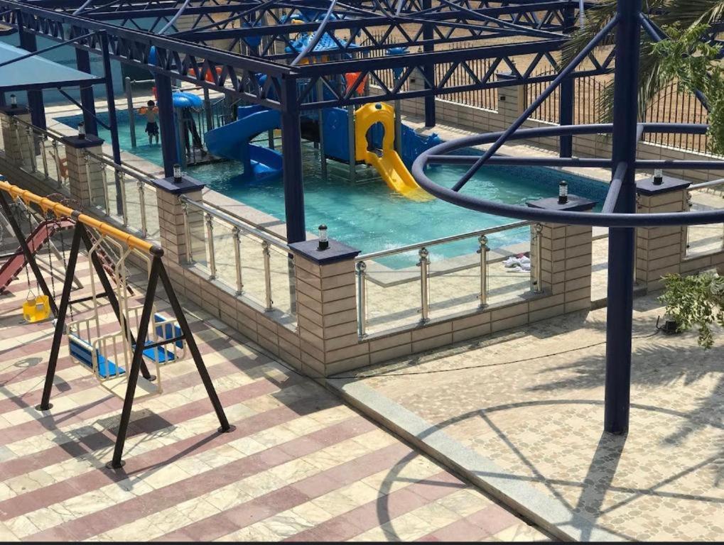 a water park with a slide in the water at منتجع شاطئ العرب الرايس in Rayyis