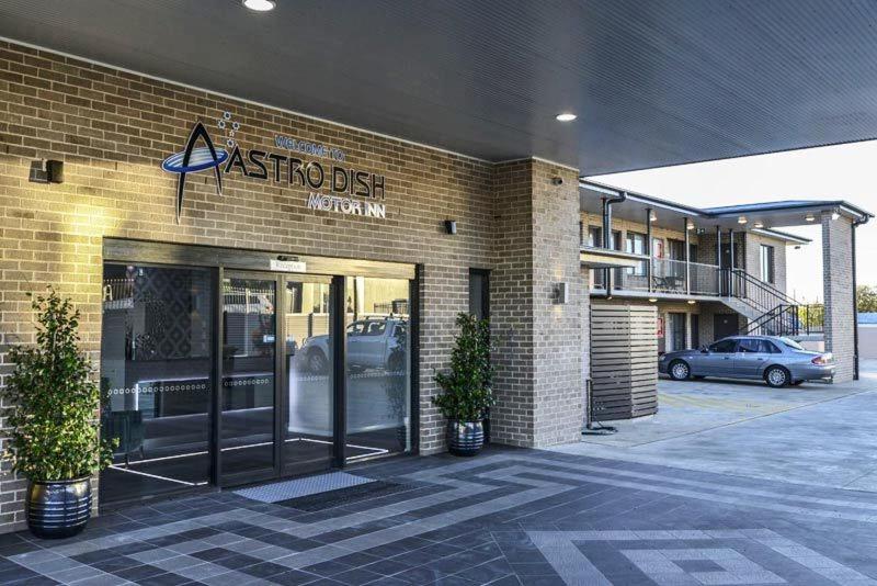 a store front of a building with a parking lot at Astro Dish Motor Inn in Parkes