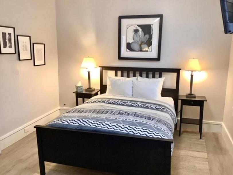 a bedroom with a bed with two end tables and two lamps at Revere Lower in Cleveland