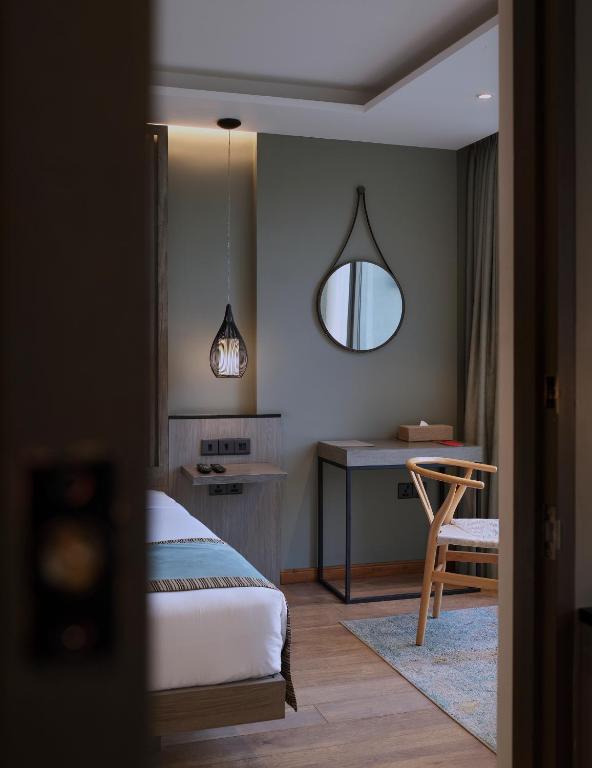 Postel nebo postele na pokoji v ubytování HIDE ELLA Hotel & Resort