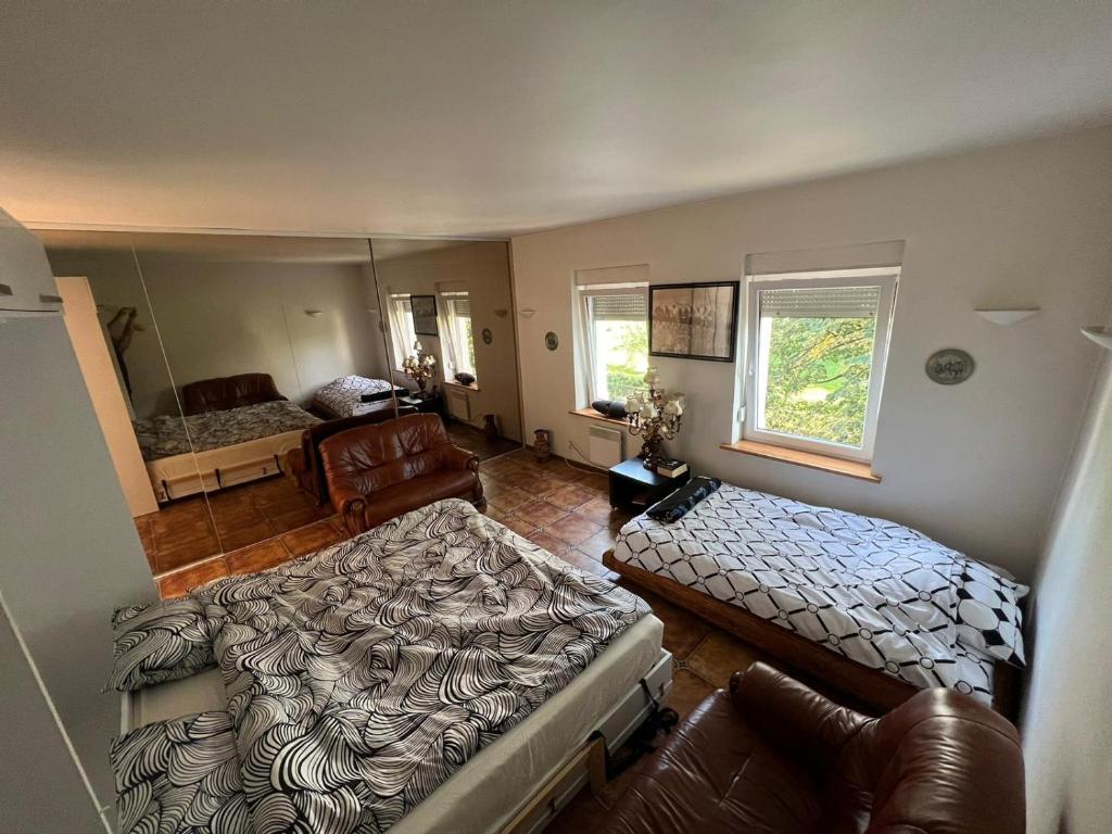 a bedroom with two beds and a living room at Apartament Zloty Pociag in Wałbrzych