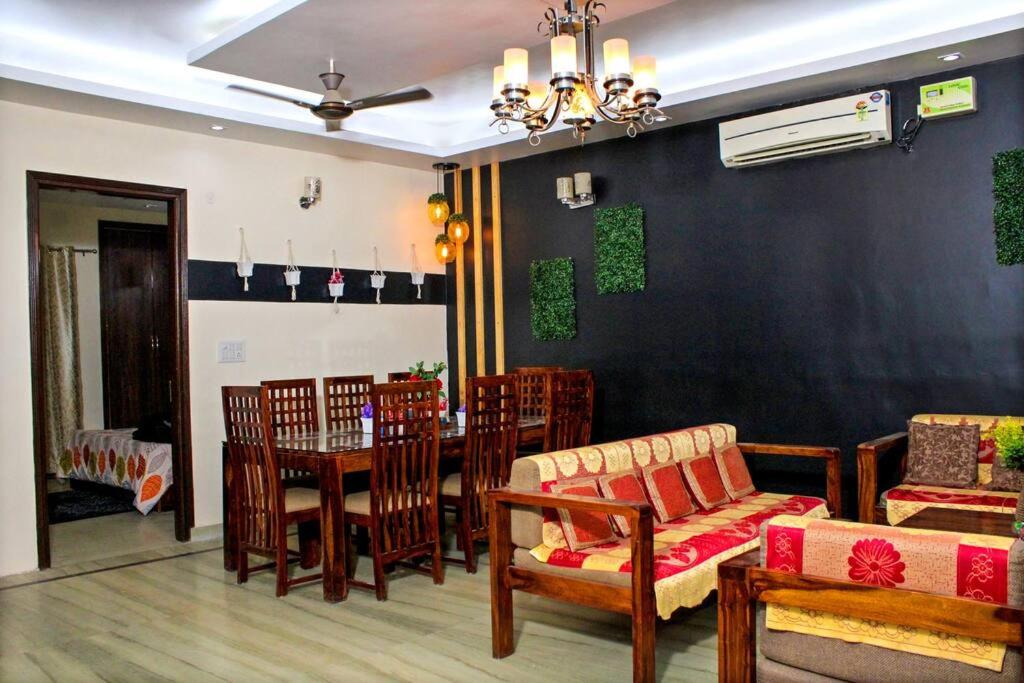 a dining room with a table and chairs at Atithi Stay By Kasa Lusso - Luxury 2 BHK In Faridabad in Faridabad