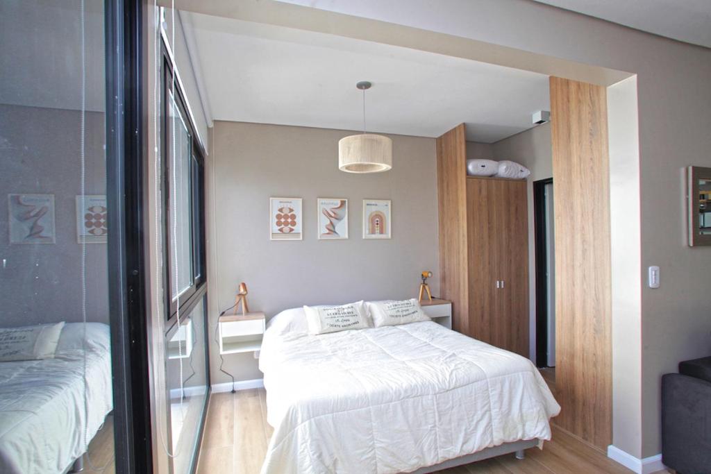a bedroom with two beds and a large window at Fancy 1BR Apartment in Nuñez in Buenos Aires