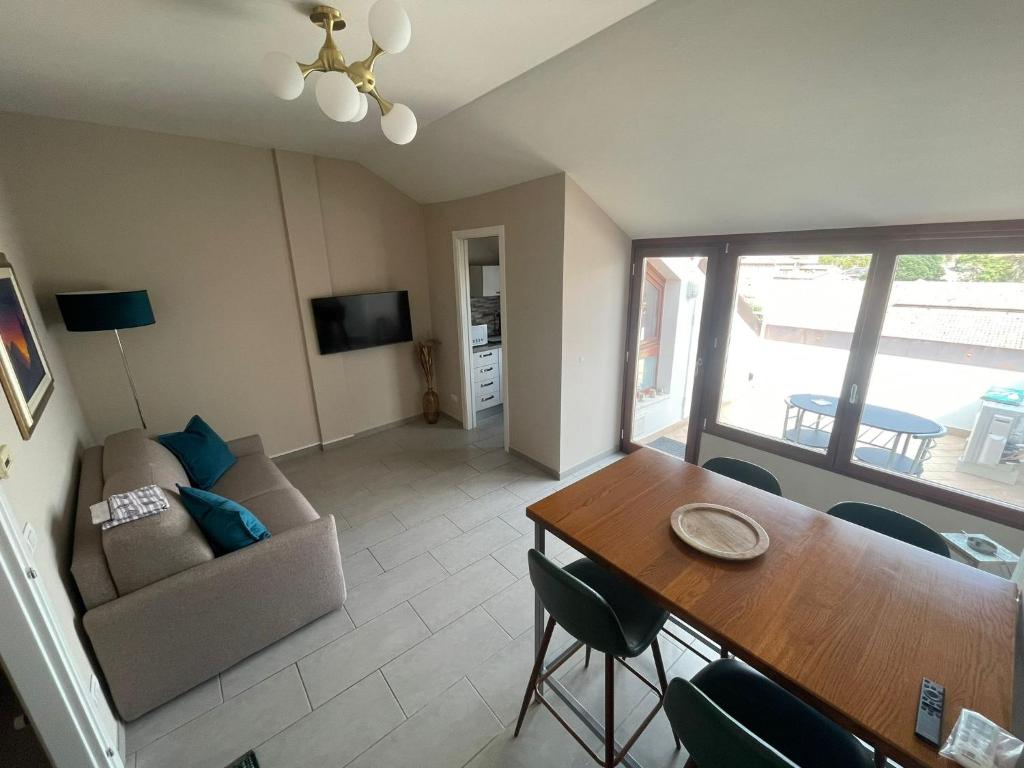 ein Wohnzimmer mit einem Tisch und einem Sofa in der Unterkunft LHE Maison Almerici in Cesena