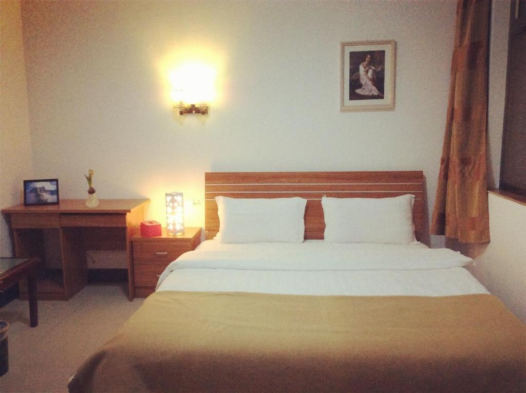 Postel nebo postele na pokoji v ubytování Huashan Gehui Hotel
