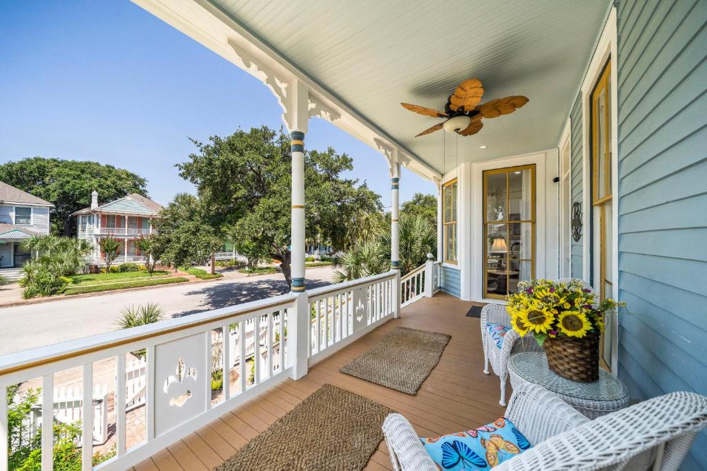 a home with a porch with chairs and flowers on it at Luxury/2bedroom/Historic/Hot tub/Fire pit in Galveston