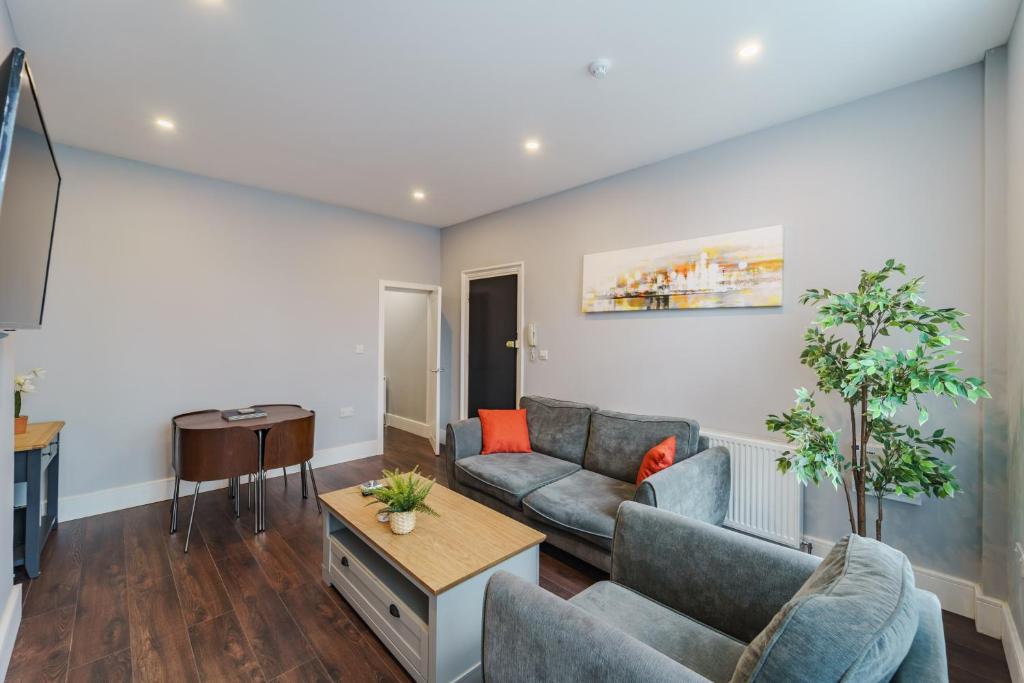 a living room with a couch and a table at Augusta House - Moseley in Birmingham