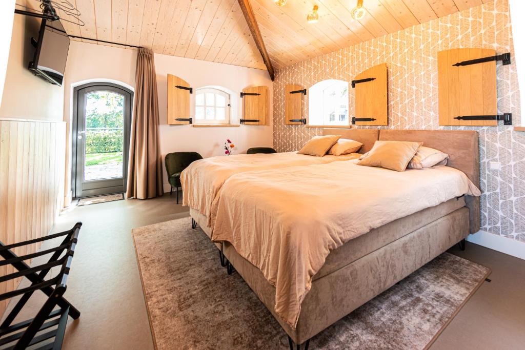 Kama o mga kama sa kuwarto sa B&B De NieuwenHof 'De Tuinkamer'