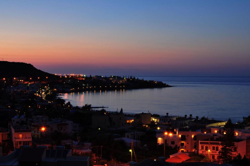 a view of the ocean at night at Hotel Thisvi in Stalís