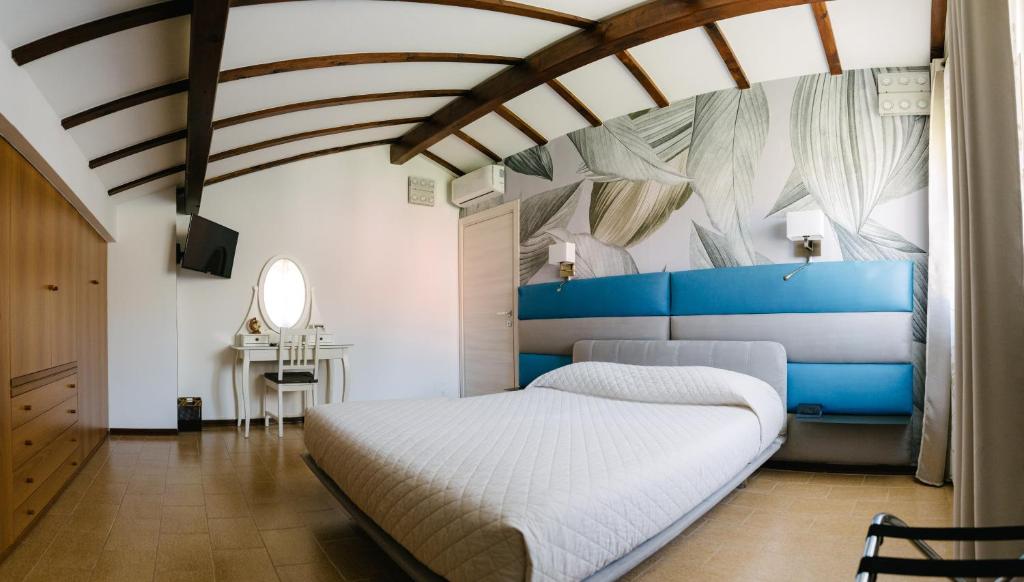 a bedroom with a bed with a blue headboard at B&B Spina Verde in Como