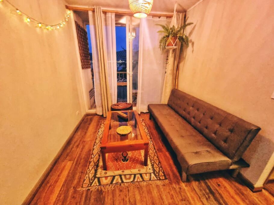 a living room with a couch and a table at Departamento Equipado Parejas in Coquimbo
