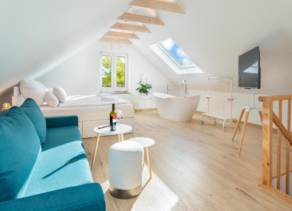 ein Wohnzimmer mit einem blauen Sofa und einer Badewanne in der Unterkunft Ferienwohnung Flensburg in Flensburg