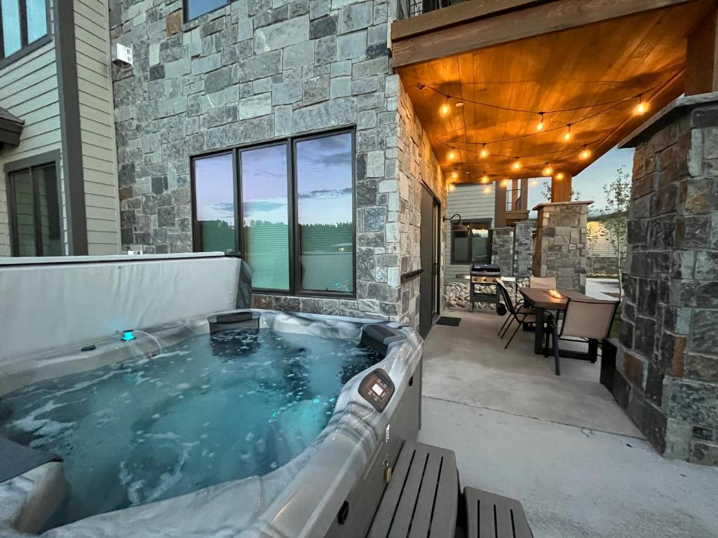 a jacuzzi tub in the backyard of a house at Brand New! Private hot tub, bunk room and walkable to restaurants/shops in Fraser