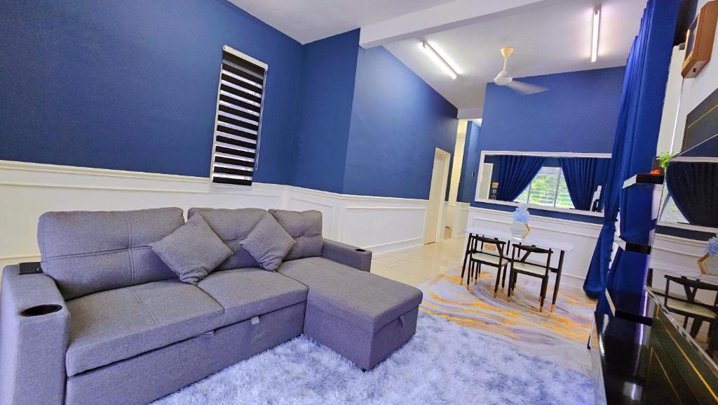 - un salon avec un canapé et une table dans l'établissement Homestay By MSH, à Seri Iskandar