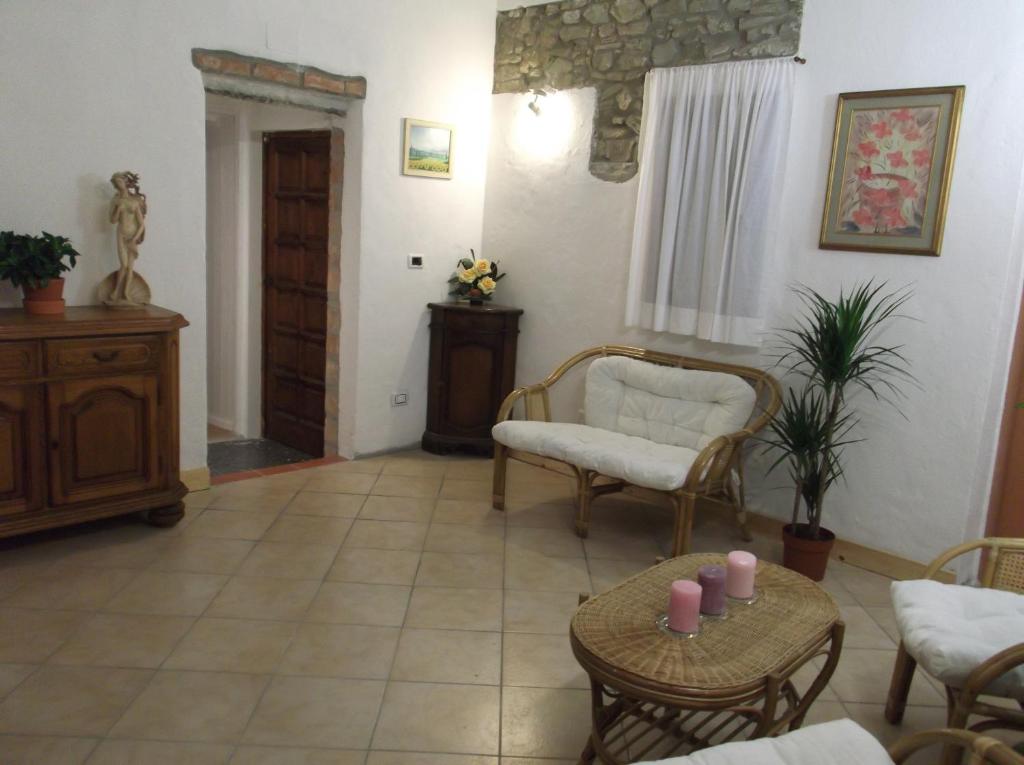 a living room with chairs and a table with candles at B&B Casa Fei in Signa