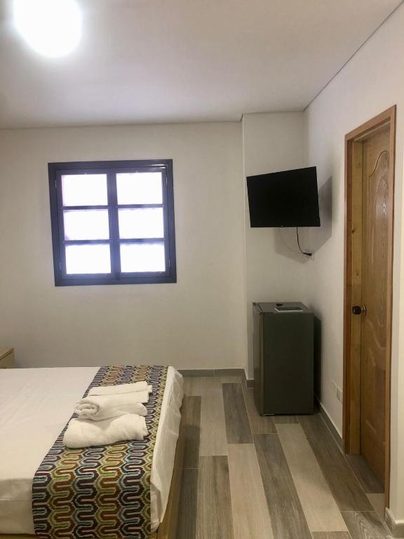 TV a/nebo společenská místnost v ubytování ALTO VERDE HOTEL