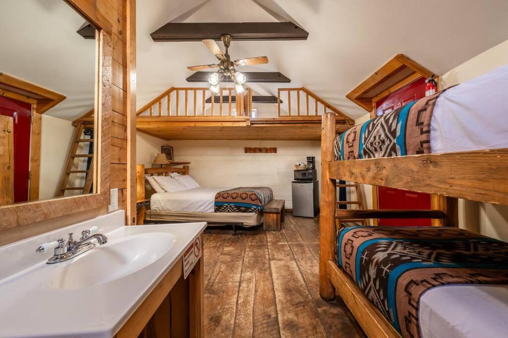 a bathroom with a sink and two bunk beds at New! Charming cozy Cabin Colorado National Forest in Lake George