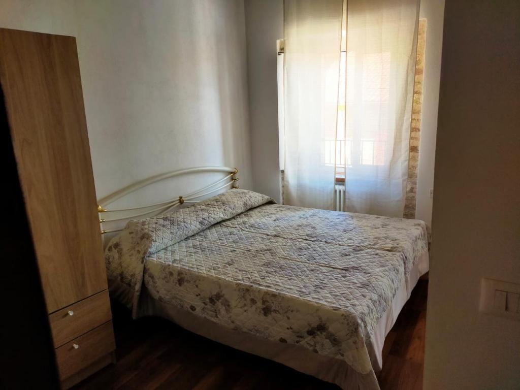 - une petite chambre avec un lit et une fenêtre dans l'établissement ANGELA 13, à Loreto