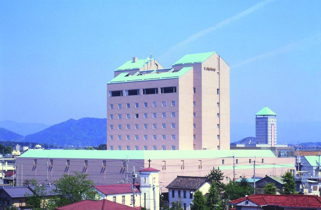 a large building in a city with buildings at Hotel New Omi in Omihachiman