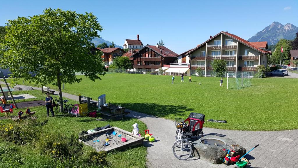an aerial view of a park with people playing soccer at Hotel Fluematte in Flüeli